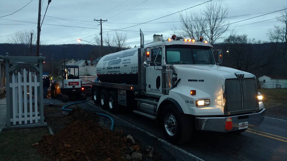 trucks working on a septic tank