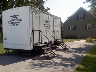 2 stall portable restroom behind a house