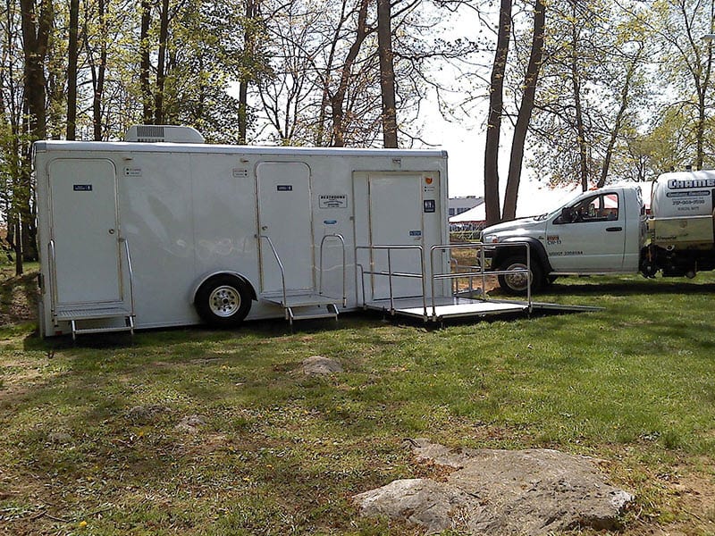 portable restroom trailer by the woods
