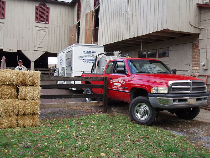 portable restroom trailer pulled by a truck